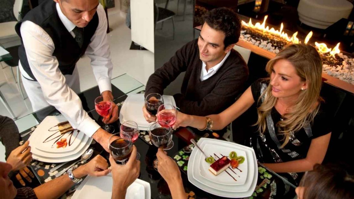 Elegant couple enjoying intimate restaurant experiences with personalized service by a cozy fireplace